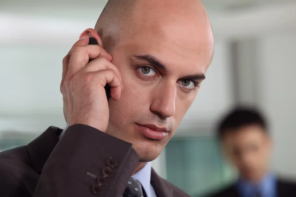 Bald businessman making telephone call — Stock Photo, Image