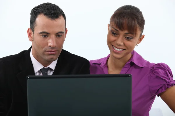 Colleagues in front of a laptop computer — Stock Photo, Image
