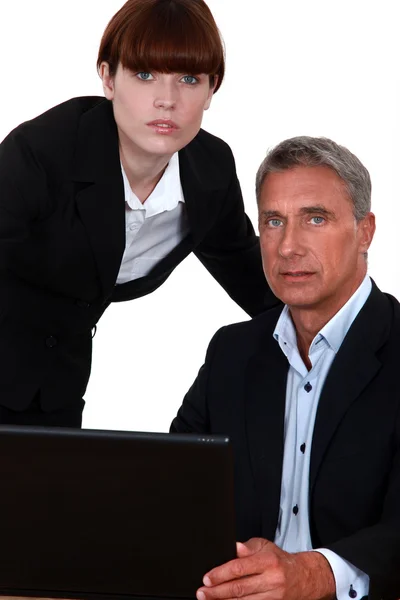 Business couple with a laptop — Stock Photo, Image