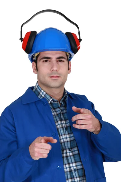 Portrait of helmeted craftsman with earmuffs showing off — Stock Photo, Image