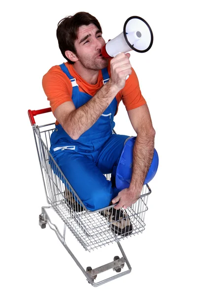 Man with a loudhailer in a trolley — Stock Photo, Image