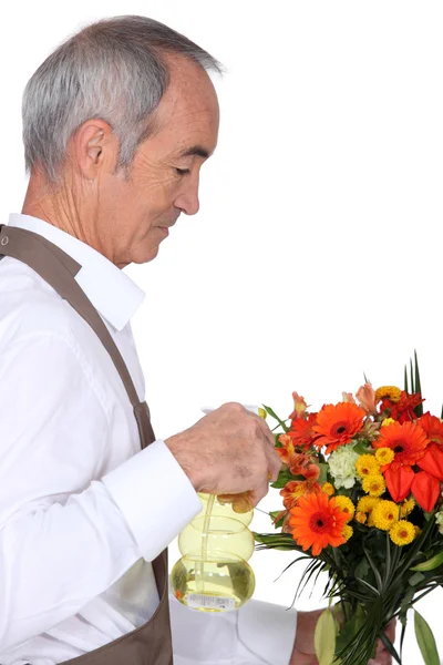 Homme pulvérisation de fleurs — Photo