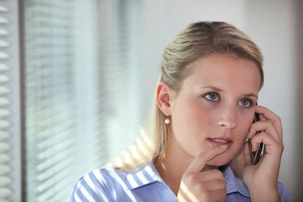 Thoughtful office worker mid phone call Stock Picture