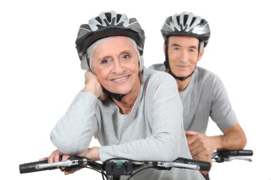 An elderly couple riding their bikes together clipart