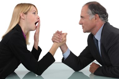 Woman arm wrestling with her boss clipart