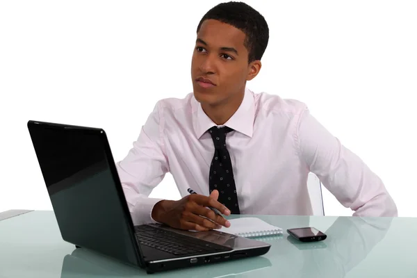 Young man thinking about what to write — Stock Photo, Image