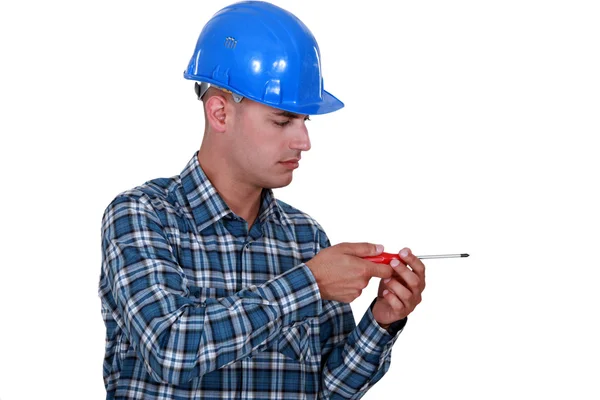 An electrician faking to screw something. — Stock Photo, Image