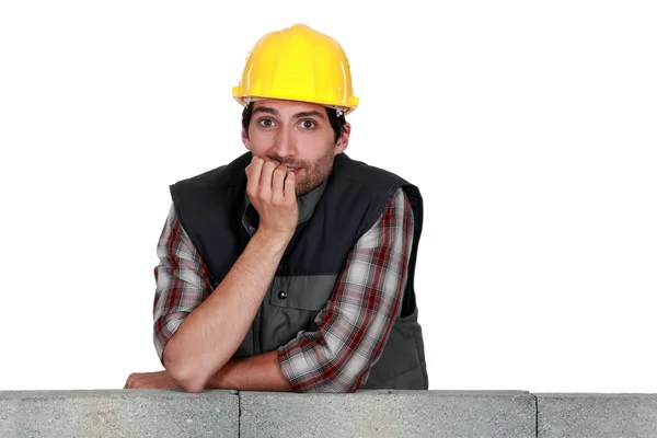 A mason biting his nails. — Stock Photo, Image