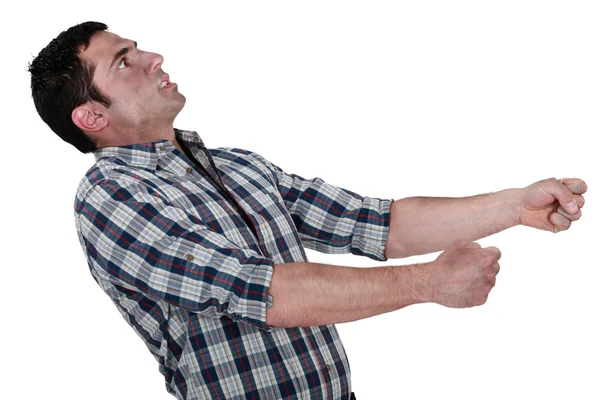 Exhausted man pulling an invisible object — Stock Photo, Image