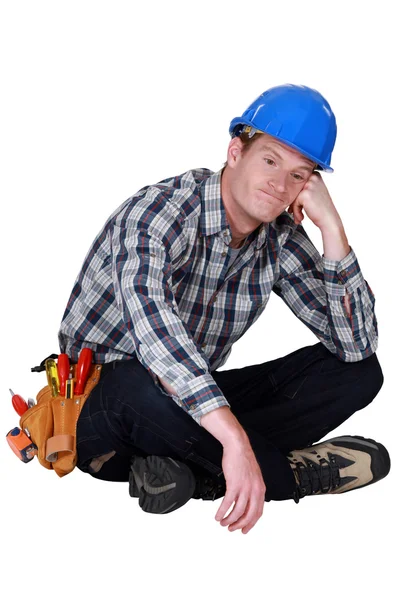 Bored manual worker sat cross-legged — Stock Photo, Image