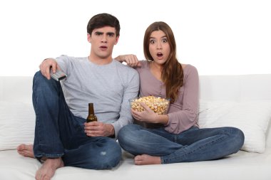 Couple on sofa with popcorn clipart