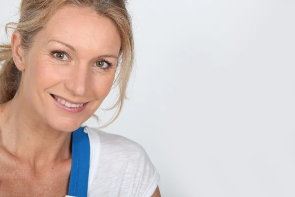 Close up of a woman in blue dungarees — Stock Photo, Image