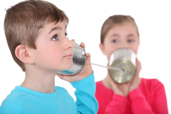 Brother and sister communication via sting and tin — Stock Photo, Image