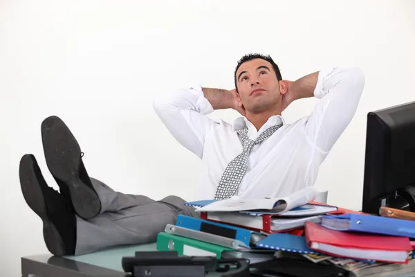 Businessman reclining in his chair despite being overworked — Stock Photo, Image