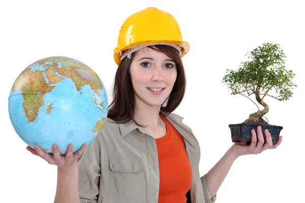 Woman with globe and bonsai — Stockfoto