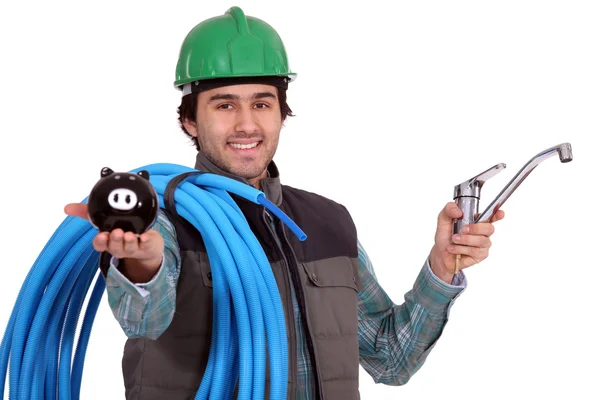 Craftsman with and piggy bank — Stock Photo, Image