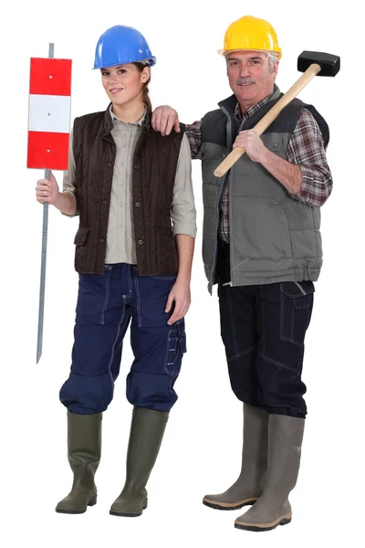 Craftsman and young apprentice posing together — Stock Photo, Image