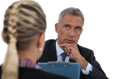 Businessman interviewing a young woman clipart