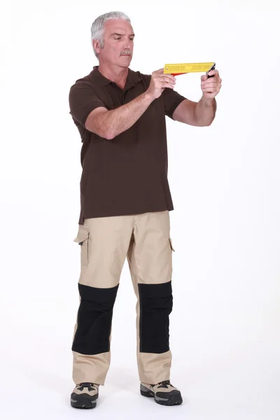 Man holding a try square — Stock Photo, Image