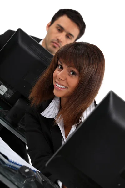 Woman peeking out from behind her computer — Stock Photo, Image