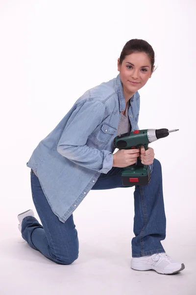 Portrait of cute brunette holding electric drill Stock Image