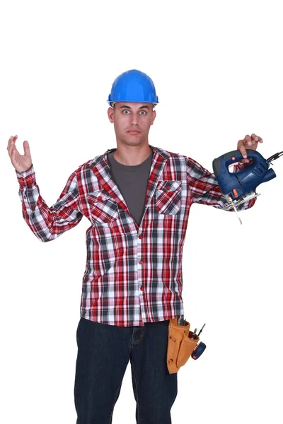 Alarmed man with a saw — Stock Photo, Image