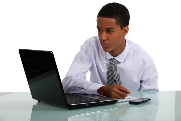 Giovane uomo d'affari guardando il suo computer portatile — Foto Stock