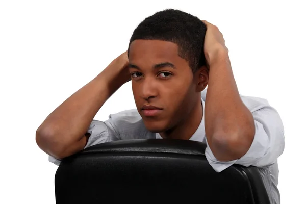 Bored young businessman sat on office chair — Stock Photo, Image