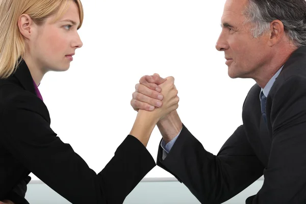 Boss and employee having an arm wrestle — Stock Photo, Image