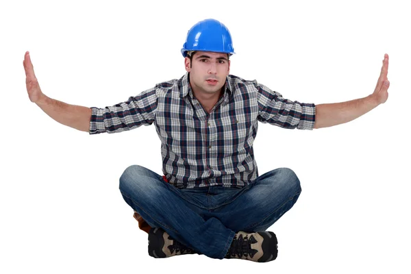 Builder sat on floor cross-legged — Stock Photo, Image