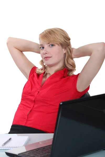 Blond woman relaxing at desk — Stock Photo, Image