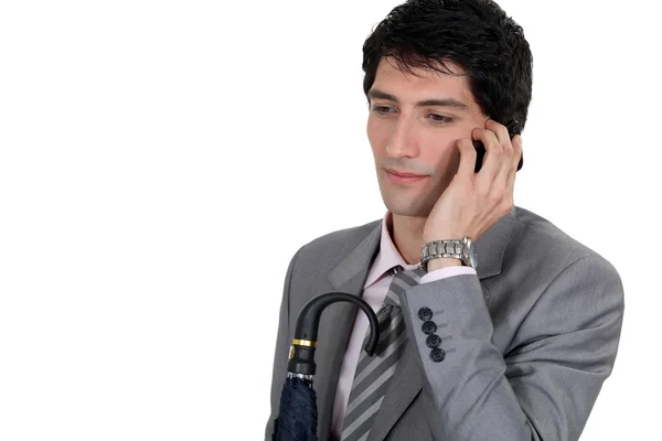 Zmęczony biznesmen mówić na jego telefon komórkowy — Zdjęcie stockowe