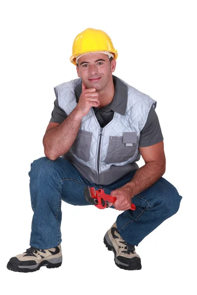 A kneeled plumber. — Stock Photo, Image