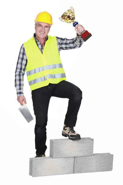 Successful laborer on a podium — Stock Photo, Image