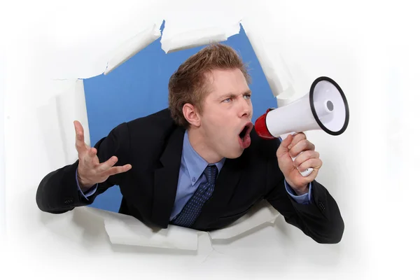 Homem de negócios irritado gritando através de megafone — Fotografia de Stock