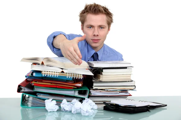 Man giving his hand over a pile of folders — Stock Photo, Image