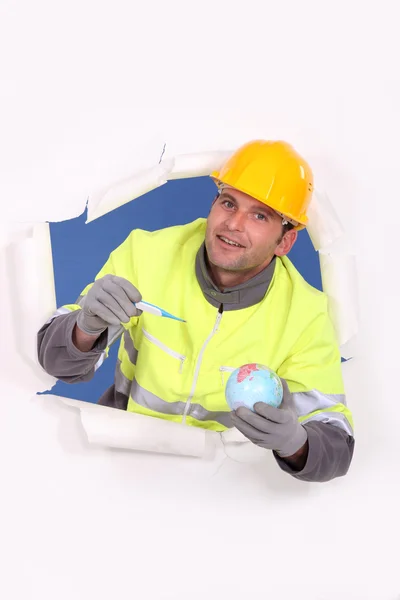 Builder with a globe and thermometer — Stock Photo, Image