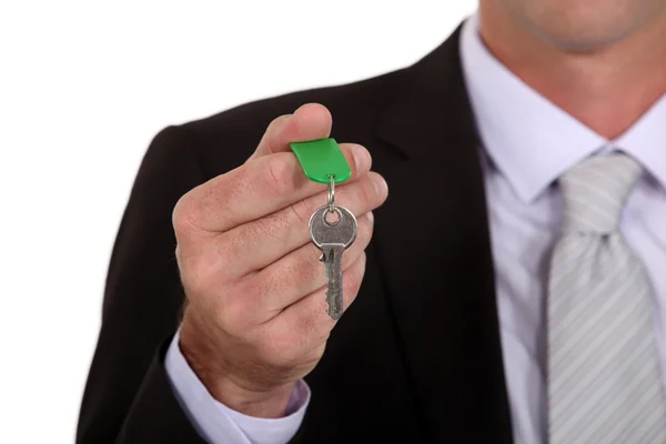 Businessman holding a key — Stock Photo, Image