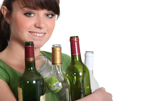 Woman recycling glass bottles — Stock Photo, Image