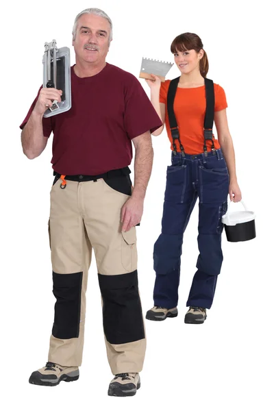 Tiler and young female assistant — Stock Photo, Image