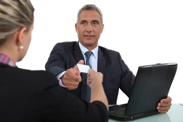 Woman handing over her business card during a meeting — Stock Photo, Image