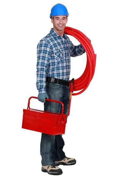 Plumber holding tool-box and plastic pipe — Stock Photo, Image