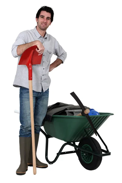 Man stood with spade and wheelbarrow — Stock Photo, Image