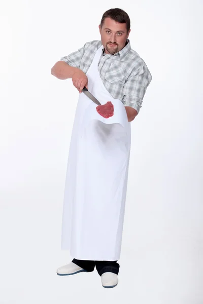 Butcher with knife and steak — Stock Photo, Image