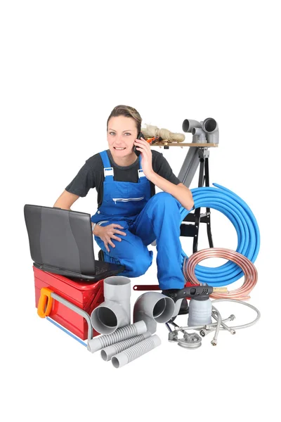 Tradeswoman surrounded by building materials and technology — Stock Photo, Image