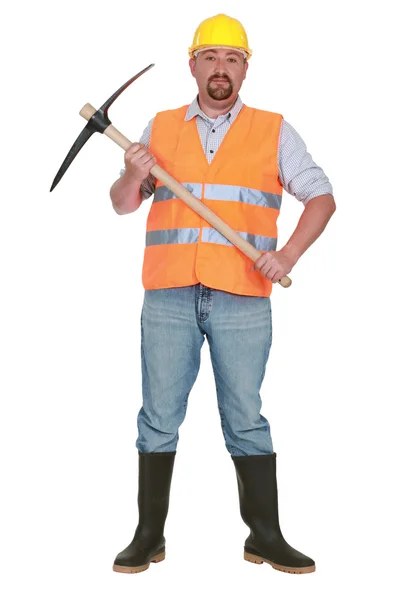 Bricklayer holds pickaxe against studio background — Stock Photo, Image