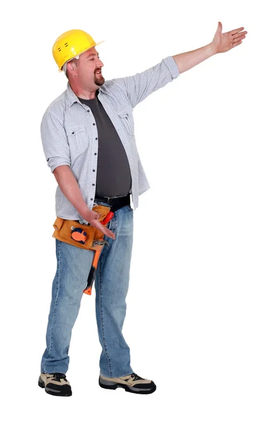 Tradesman presenting an invisible object — Stock Photo, Image