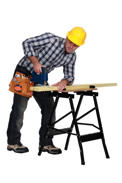 Man sawing plank of wood — Stock Photo, Image