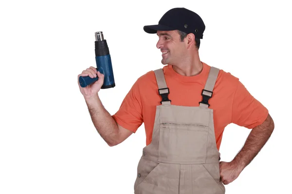 Craftsman holding a heat gun — Stock Photo, Image