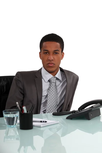 Young executive sitting by the phone — Stock Photo, Image